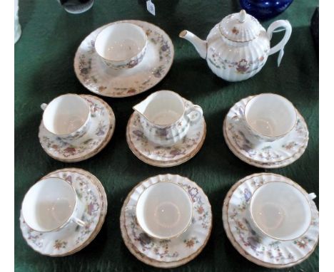 A Royal Worcester Pekin pattern part-tea service, comprising five trios, teapot, sandwich plate, sugar bowl and milk jug.