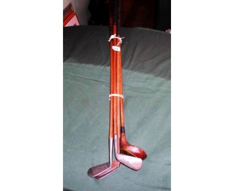 A collection of five golf clubs, early 20th century, each with wooden shafts, to include examples by Spalding Argyle, Army & 