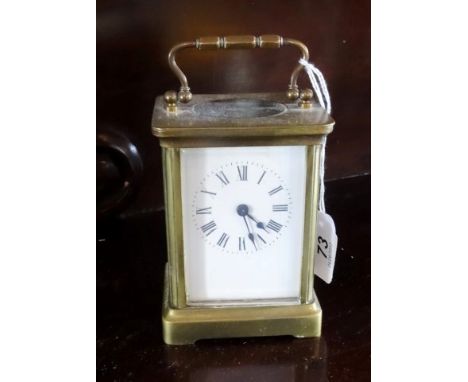 A gilt brass carriage clock, the enamel dial bearing Roman numerals, 13.5cm (handle up).
