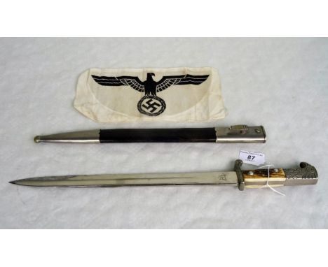 A mid 20th century German dress dagger and scabbard, the blade signed Alexander Coppel, together with a cloth Third Reich sas