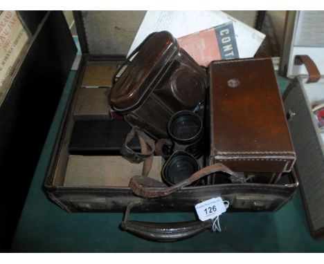 An early 20th century brown leather suitcase containing a quantity of camera equipment, to include: Bromide Lantern plates, t