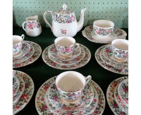 A Crown Staffordshire bone china tea service, a six place setting, comprising: trios, salad plates, teapots, sugar bowl, milk