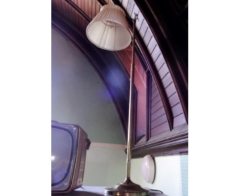 A brass standard lamp on circular foot.