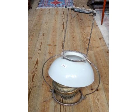 A brass ceiling oil lamp and opaline shade.