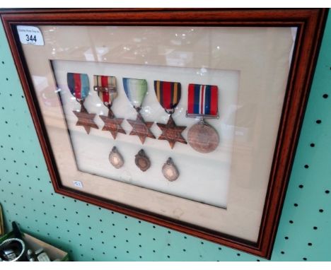 A framed and glazed WWII medal presentation group, to include: Campaign medal, 1939/45 Star, Atlantic star, Burma star and Af