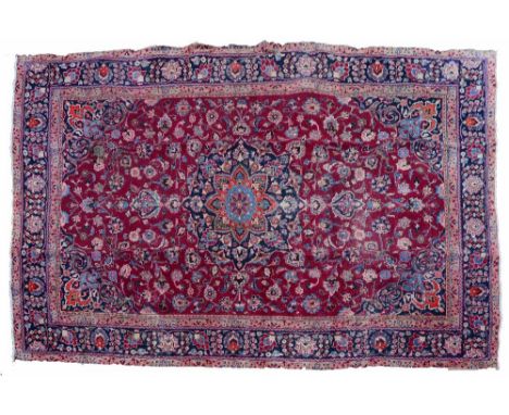 A Mahal red ground small carpet  with central floral medallion and trailing foliate designs within a dark blue banded border,