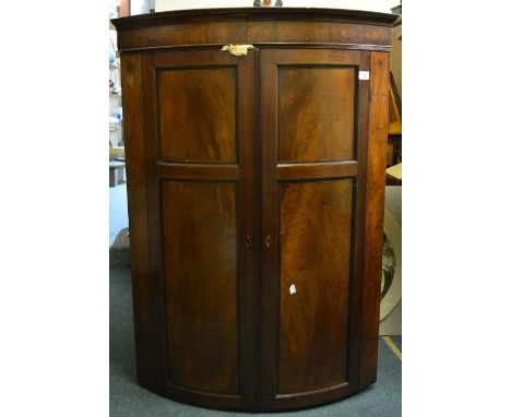A 19th Century mahogany bow front corner cupboard with ebony line inlay, 110cm high