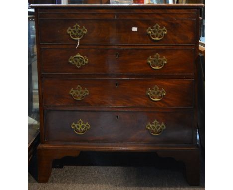 A George III mahogany secretaire chest the upper drawer fitted with an arrangement of drawers and pigeon holes above three lo