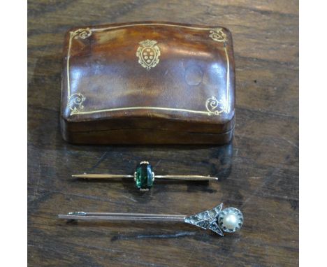 A bar brooch  mounted with a peridot, a pearl mounted Art Deco style stick pin and a small leather and gilt box