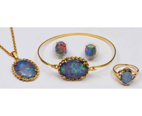 A 9ct ring set with an opal, together with a pair of opal earrings, an opal set pendant necklace, an opal set bangle etc