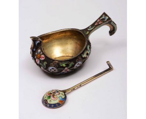 A Russian silver gilt and enamel small kovsh late 19th/early 20th Century decorated with stylised flowers and motifs on a bla