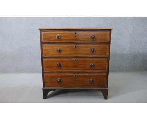 A 19th century mahogany chest of four long graduated drawers, with lion mask ring handles, on bracket feet. H.97 W.91 D.48cm 