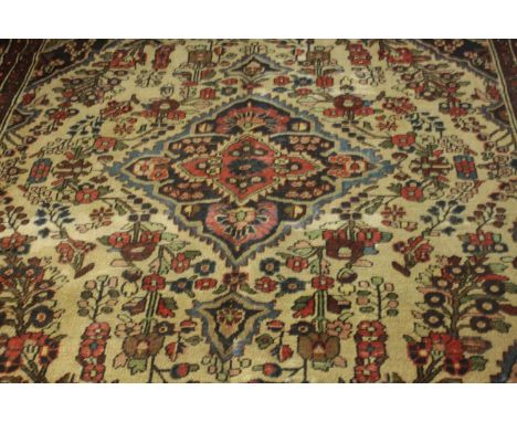 A Persian Hamadan cream ground hand made carpet. L.280 W.230cm. 