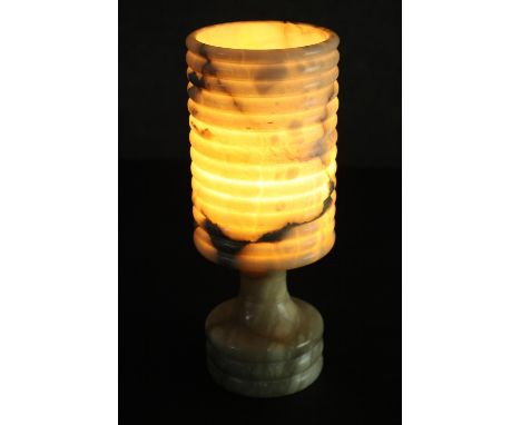 A circa 1970s light coloured onyx table lamp, of cylindrical form with a ribbed shade and base. H.26 Dia.10cm. 