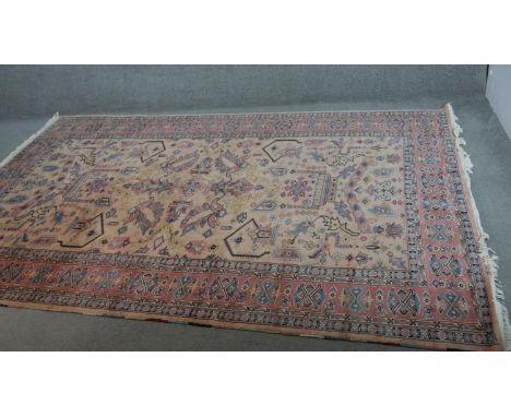 A handmade Indian part-silk Agra carpet, on a beige ground. L.290 W.188cm. 