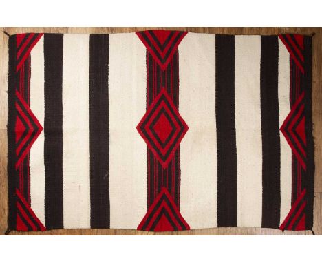 Black and white striped chieftain's Navaho rug with a geometric design in red, approximately 119cm x 182.5cm  With signs of w