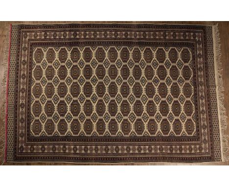 Afghan sofa carpetof cream/ivory ground with Bokhara style design, within a geometric border, 193cm x 300cm  The carpet has s