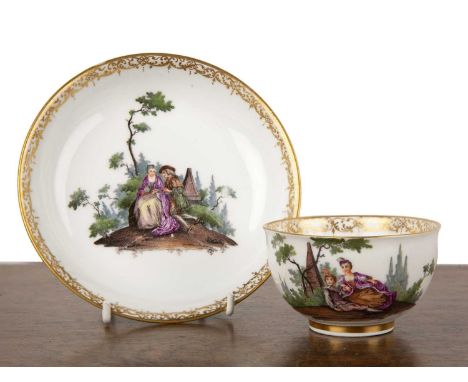 Meissen cabinet cup and saucer18th/19th Century, painted with a fete galante scene after Watteau  Light wear to the gilding a
