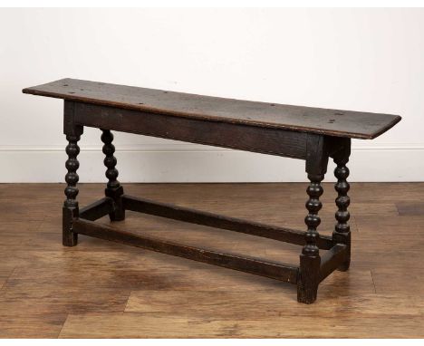 Oak bench late 17th/18th Century, with bobbin supports, 135.5cm wide x 34cm deep x 55.5cm high  With overall looseness. With 