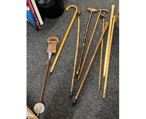Selection of vintage walking sticks and one shooting stick