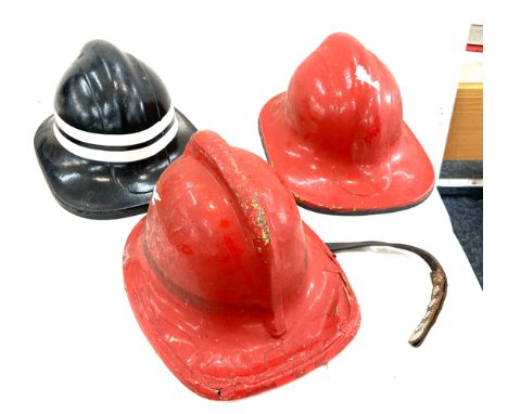 Three vintage fire mans helmets