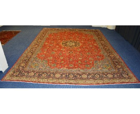 A Sarough carpet, the central red, blue and cream floral motif on red floral ground, with red and blue floral border, 398 x 2