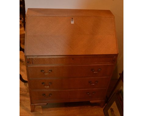 A light oak writing bureau, with drop flap enclosing pigeon holes above three drawers, 98cm high x 77cm wide x 39cm deep