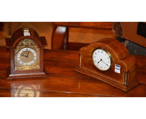 A 1930's oak mantle clock, the white enamel dial with Arabic numerals, set within satinwood inlaid arched front, mounted by b