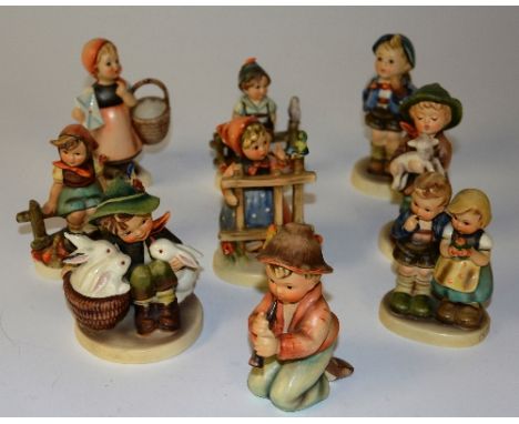 A collection of nine Hummel figures, marked W Goebel to base, tallest 12cm high (9)