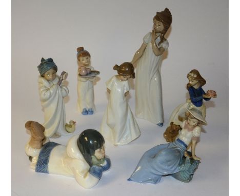 A boxed Lladro figure, 16cm high, together with six boxed Nao figures (7)   CONDITION REPORT:  Lot 169 the Lladro figure is t