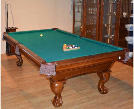 An American 8½ ft pool table with slate bed by Brunswick, to include balls, cues, holder and triangle, with mother of pearl d