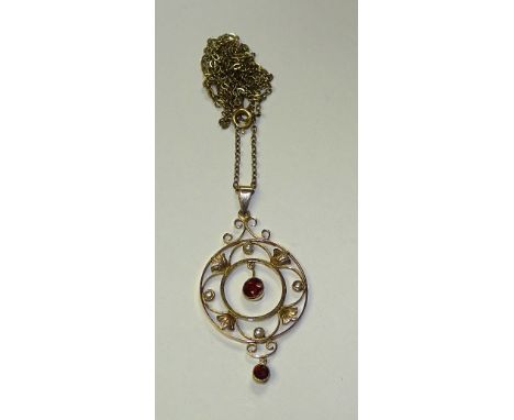 A 9ct gold ruby and seed pearl pendant, with two round cut ruby drops to centre and base, on circular gold mount with four se