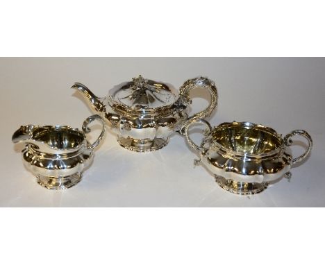 A Georgian silver teapot, hallmarks for London 1825-26 William Eley II, of gadrooned form with pie crust rim and floral finia