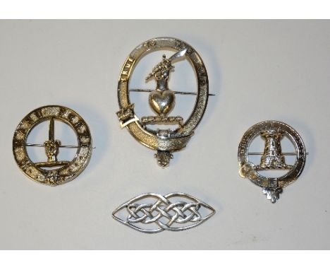 A Celtic design silver brooch, stamped MJW 925 to reverse, 10.5cm long, together with three silver/white metal Scottish clan 