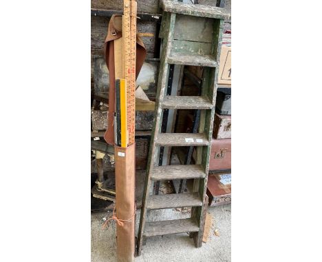 Wooden step ladder along with a tripod and side level