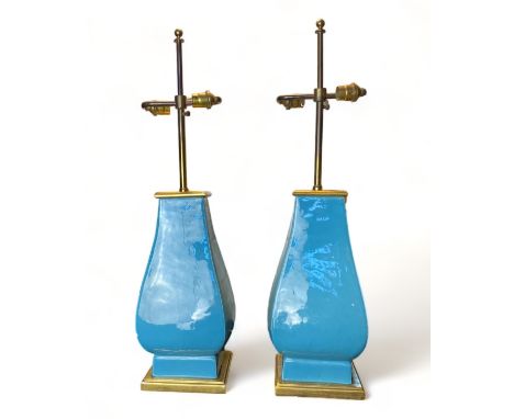 A pair of Mallets 20th century light blue ceramic twin-light table lamps    Of flattened baluster form, on gilt wood bases, t