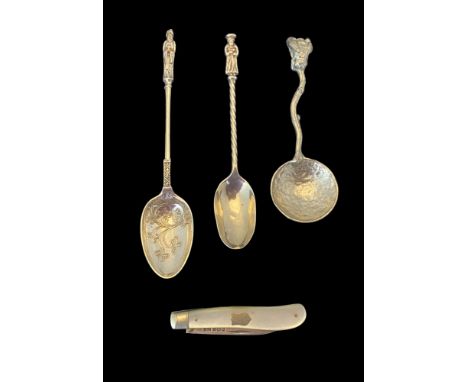 Two silver caddy spoons, another caddy spoon and a silver and mother-of-pearl fruit knife Comprising an apostle spoon with fo