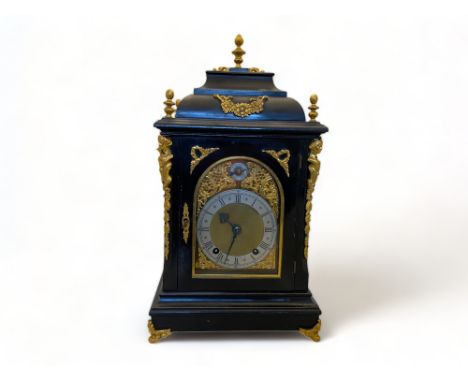 A late 19th century German ebonised and gilt metal mounted bracket clock and bracket by Winterhalder & Hoffmeier The caddy to
