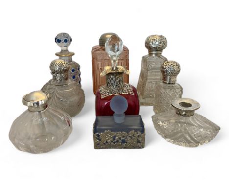 A group of cut glass dressing table bottles mostly with silver fittings&nbsp;
Comprising of a continental perfume bottle with