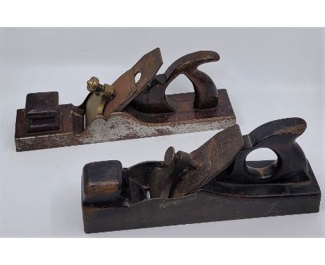 A heavy brass panel plane, with dark hardwood infill and handle and Ward iron, sole 13in., together with an iron panel plane,