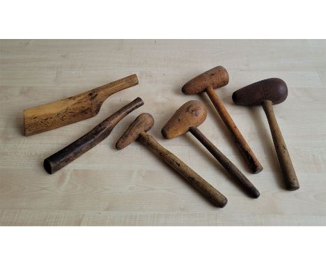 A collection of vintage wooden plumbers' lead working tools, to include: a bossing stick, a setting-up stick and dresser and 