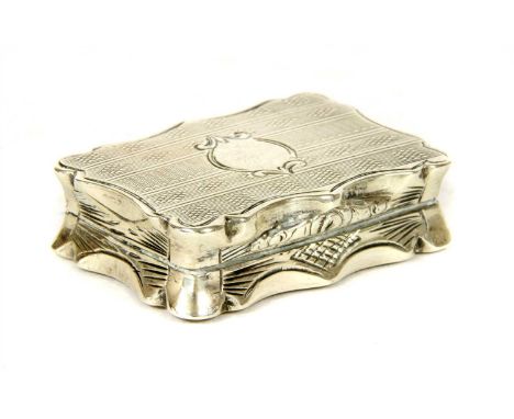 A Victorian silver vinaigrette, by Alfred Taylor, Birmingham 1866, of shaped outline with engine turned decoration and vacant