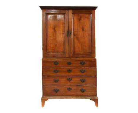 A Georgian mahogany linen press, the cupboard doors above four graduating drawers raised on bracket feet, 215cm high