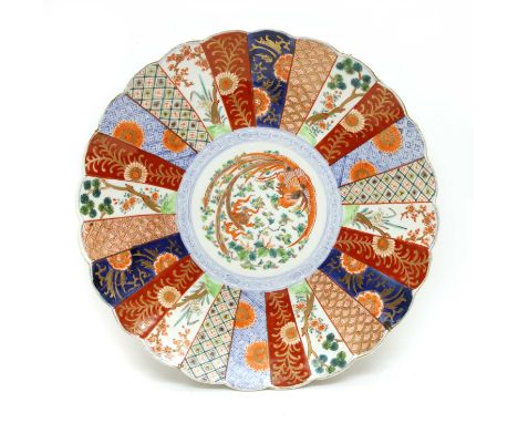 A Japanese Meiji period Imari charger, of lobed circular form, the central panel decorated with a phoenix, within further alt