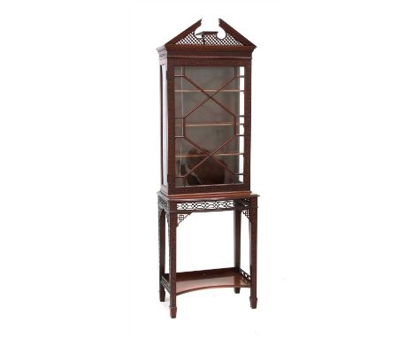 An early 20th century Chippendale style display cabinet on stand, the pierced broken pediment over an ogee moulded cornice ov