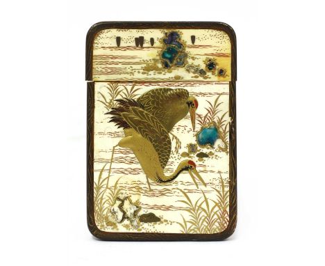 A Japanese ivory card case, Meiji period, decorated with cranes or a samurai in gilt lacquer in relief, 11cm long