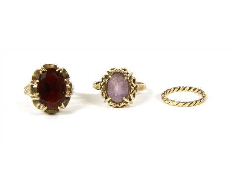 A 9ct gold single stone amethyst ring, with an oval mixed cut amethyst four claw set to a pierced gallery, with a plain shank
