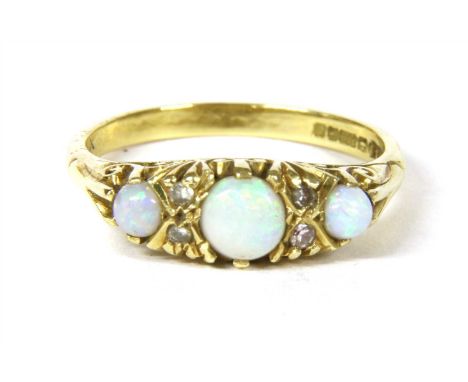 An 18ct gold three stone opal carved head style ring , with a row of graduating round cabochon opals claw set to a boat-shape