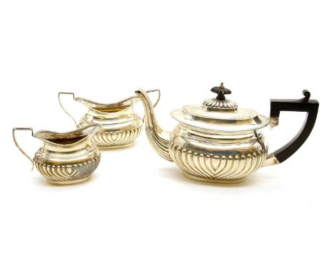 A hallmarked silver Bachelors tea service, comprising teapot, sugar bowl and cream jug, having hoop reeded body with angular 