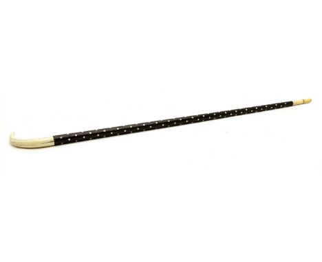 A rosewood and ivory walking stick with boar tusk , 19th century, the curved handle above a polka dot inlaid shaft, 91cm long